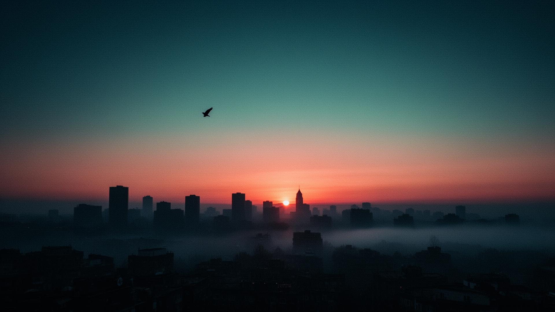 Sunrise breaking over a foggy city skyline